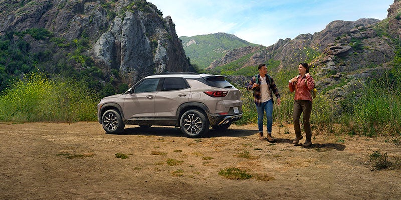Two people who just parked their 2026 Chevrolet Trailblazer and are about to start a hike.