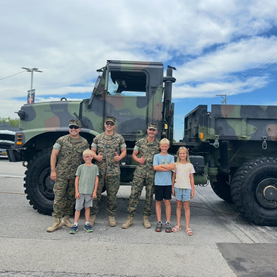 Soldiers, truck, and children